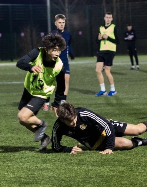 AMFA players competing for the ball under floodlights