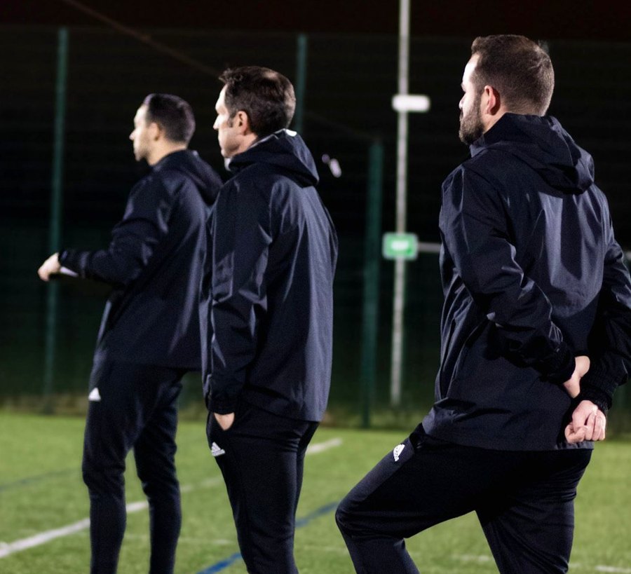 Coaches watching an AMFA session from the touchline